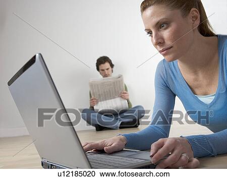 Stock Image - Couple with computer and paper. Fotosearch