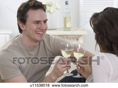 Couple with glasses of white wine View Large Photo Image Stock Photo - Couple with glasses of white wine. Fotosearch