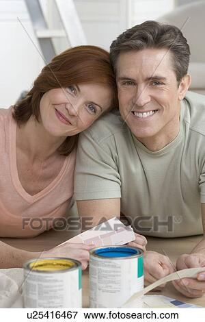 Stock Photo - Couple with paint and color samples. Fotosearch