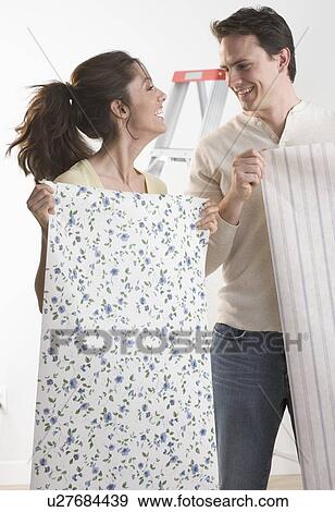 Couple with wallpaper and ladder View Large Photo Image Stock Photo - Couple with wallpaper and ladder. Fotosearch