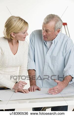 Stock Photograph - Couple working on their home. Fotosearch