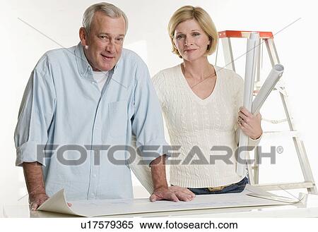 Couple working on their home View Large Photo Image Stock Photography - Couple working on their home. Fotosearch