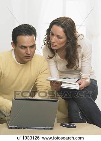 Couple working together at computer View Large Photo Image Stock Photograph - Couple working together at computer. Fotosearch