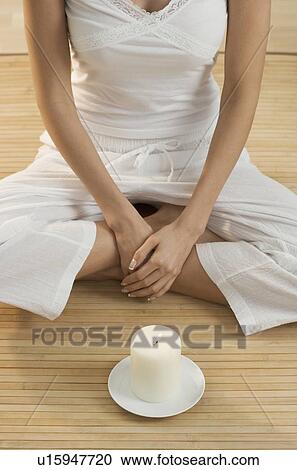 Cross-legged woman's torso with candle View Large Photo Image Stock Image - Cross-legged woman's torso with candle. Fotosearch