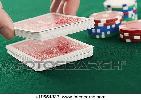Stock Image - Cutting cards on poker table. Fotosearch