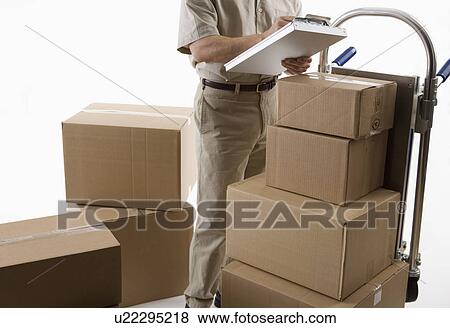 Stock Photo - Delivery man with packages. Fotosearch