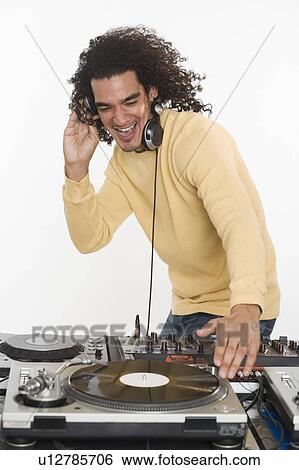 DJ working at music mixing board View Large Photo Image Stock Photograph - DJ working at music mixing board. Fotosearch