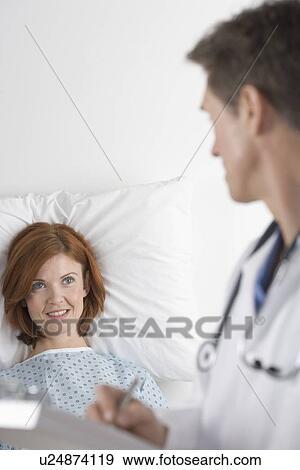 Stock Photo - Doctor consulting with patient. Fotosearch