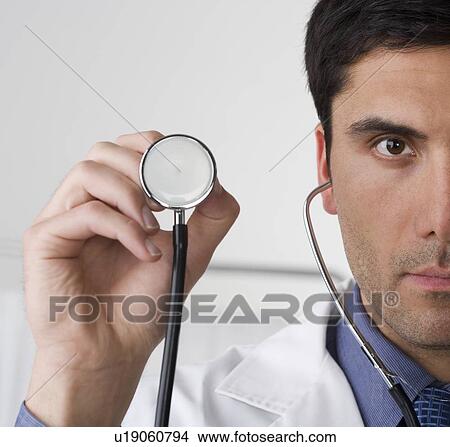 Picture - Doctor holding stethoscope. Fotosearch