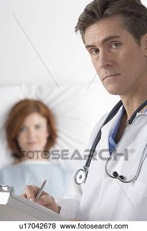 Doctor visiting with patient View Large Photo Image Stock Photo - Doctor visiting with patient. Fotosearch
