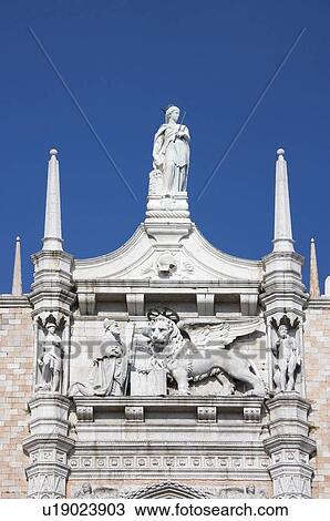 Stock Image - Doges' Palace with Statue of the Doge before the Symbol of Venice Italy. Fotosearch