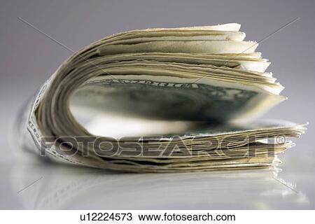 Stock Image - Dollar bills folded in half. Fotosearch