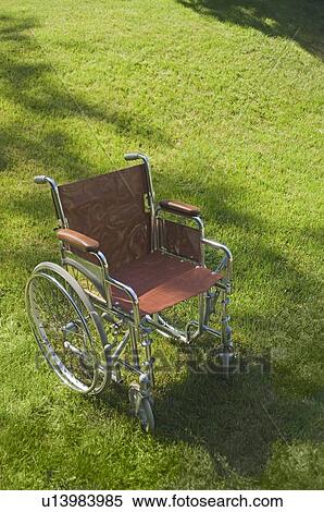 Empty wheelchair on a lawn View Large Photo Image Stock Photography - Empty wheelchair on a lawn. Fotosearch