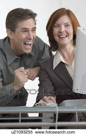 Excited business people at computer View Large Photo Image Stock Photography - Excited business people at computer. Fotosearch