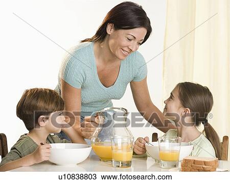 Family eating breakfast View Large Photo Image Stock Image - Family eating breakfast. Fotosearch