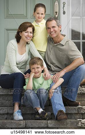 Stock Image - Family sitting on front steps. Fotosearch