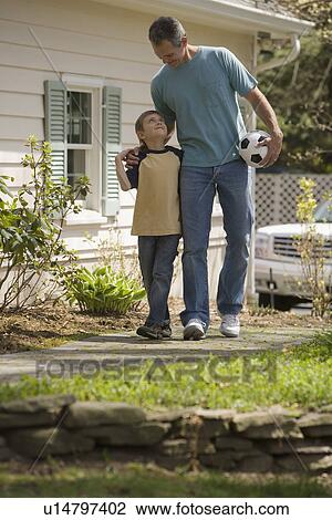 Stock Image - Father and young son with soccer ball. Fotosearch