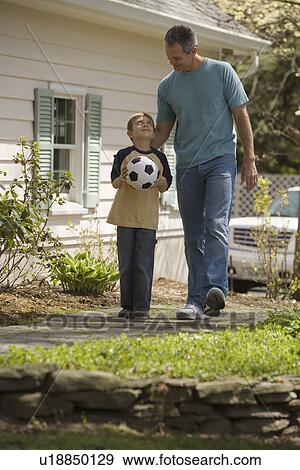 Stock Photo - Father and young son with soccer ball. Fotosearch