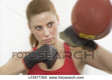Female boxer hitting punching bag View Large Photo Image Stock Photography - Female boxer hitting punching bag. Fotosearch