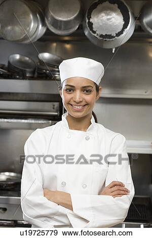Stock Photo - Female chef in restaurant kitchen. Fotosearch