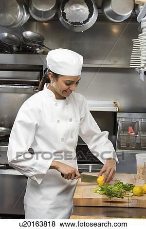 Female chef in restaurant kitchen View Large Photo Image Stock Photo - Female chef in restaurant kitchen. Fotosearch