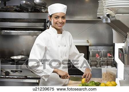 Stock Photography - Female chef in restaurant kitchen. Fotosearch