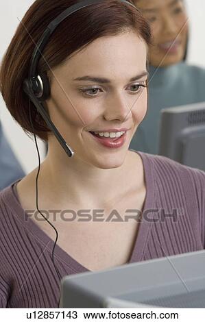 Stock Image - Female customer service representative. Fotosearch