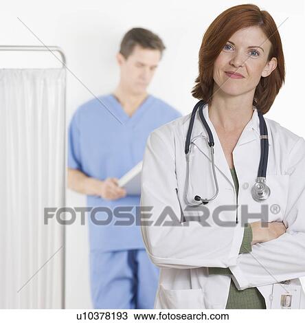 Stock Image - Female doctor smiling confidently. Fotosearch