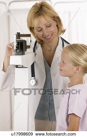 Stock Photo - Female doctor with little girl patient. Fotosearch