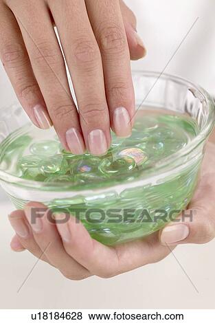 Stock Photo - Female fingers in a dish of aloe gel. Fotosearch