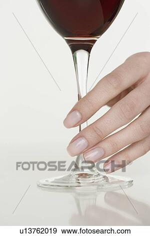 Stock Photo - Female hand holding glass of wine. Fotosearch
