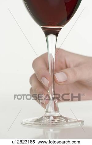 Stock Photography - Female hand holding glass of wine. Fotosearch