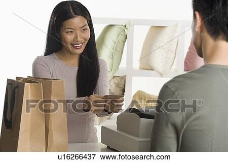 Stock Photo - Female sales person assisting customer. Fotosearch