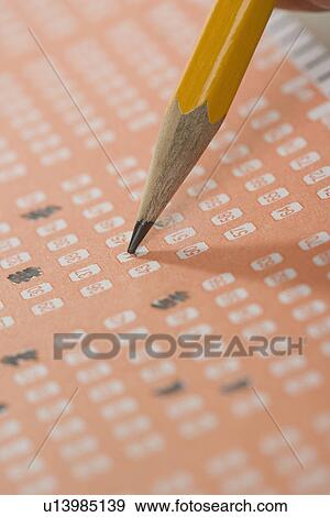 Stock Photo - Filling out a lottery ticket. Fotosearch