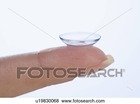 Stock Photo - Finger with contact lens. Fotosearch