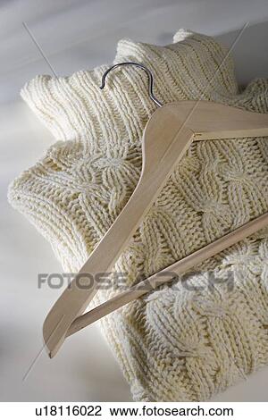 Folded sweater with hanger View Large Photo Image Stock Image - Folded sweater with hanger. Fotosearch