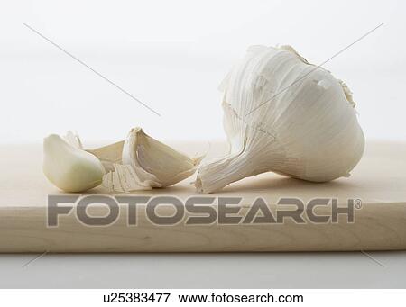 Garlic on cutting board View Large Photo Image Stock Photo - Garlic on cutting board. Fotosearch