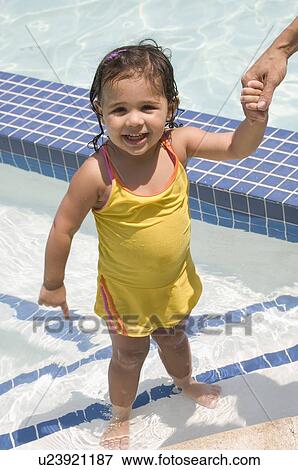 Girl standing in swimming pool View Large Photo Image Stock Photo - Girl standing in swimming pool. Fotosearch