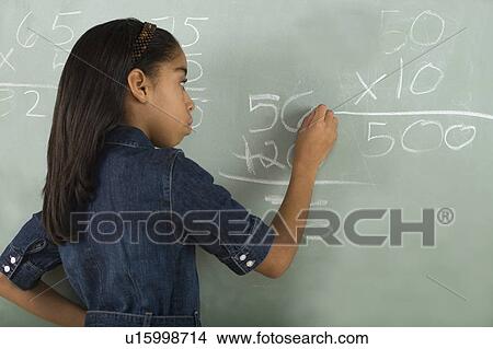 Girl writing on chalkboard View Large Photo Image Picture - Girl writing on chalkboard. Fotosearch