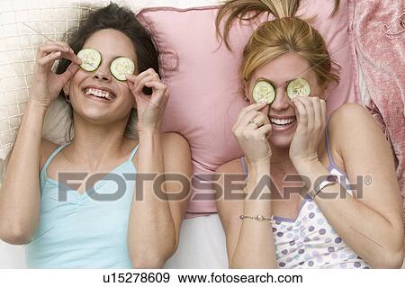 Girls with cucumbers on eyes View Large Photo Image Stock Photo - Girls with cucumbers on eyes. Fotosearch