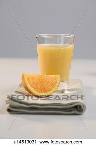 Glass of juice and orange slice View Large Photo Image Stock Image - Glass of juice and orange slice. Fotosearch
