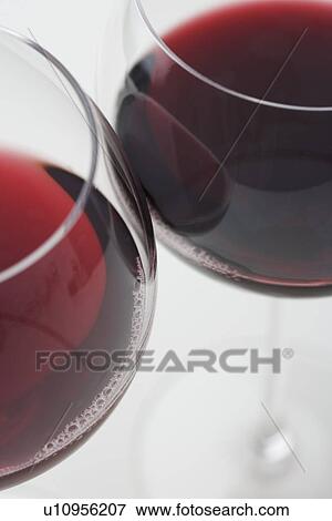 Glasses of red wine touching View Large Photo Image Stock Photo - Glasses of red wine touching. Fotosearch