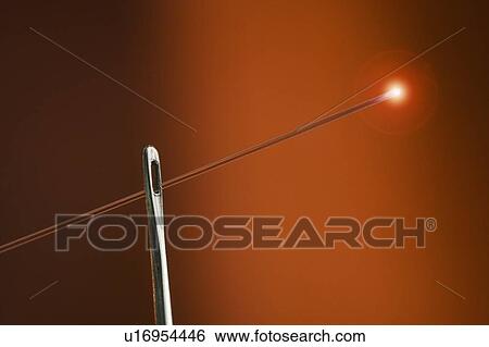 Stock Photograph - Glowing fiber optic thread with needle. Fotosearch