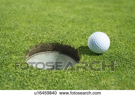 Golf ball near cup on putting green outdoors View Large Photo Image Stock Image - Golf ball near cup on putting green outdoors. Fotosearch