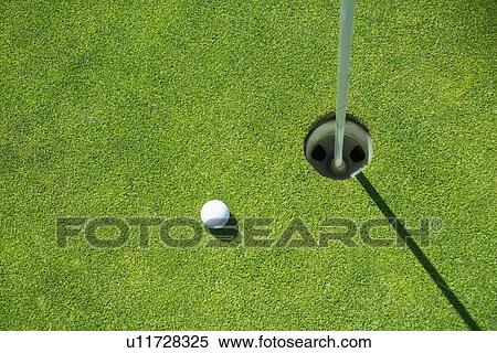 Golf ball near cup on putting green outdoors View Large Photo Image Stock Photography - Golf ball near cup on putting green outdoors. Fotosearch