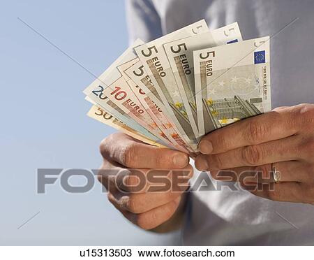 Hand holding Euro notes View Large Photo Image Stock Image - Hand holding Euro notes. Fotosearch