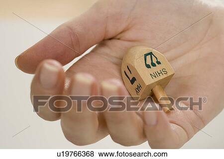 Hand holding Jewish Dradle View Large Photo Image Stock Photo - Hand holding Jewish Dradle. Fotosearch