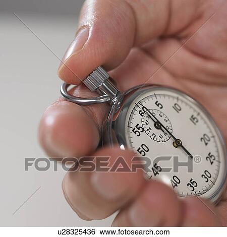 Hand holding stop watch View Large Photo Image Stock Photograph - Hand holding stop watch. Fotosearch