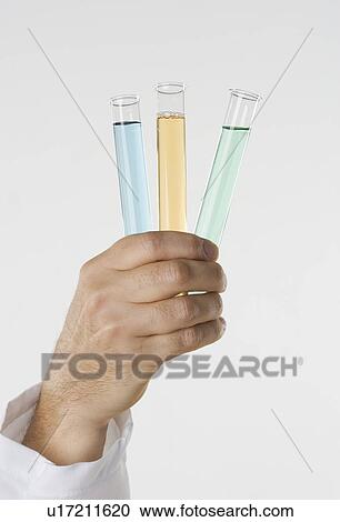 Hand holding test tubes View Large Photo Image Stock Image - Hand holding test tubes. Fotosearch