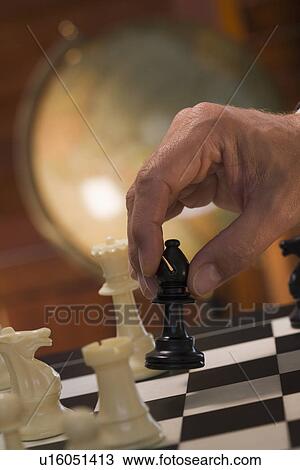 Hand moving chess piece View Large Photo Image Stock Image - Hand moving chess piece. Fotosearch